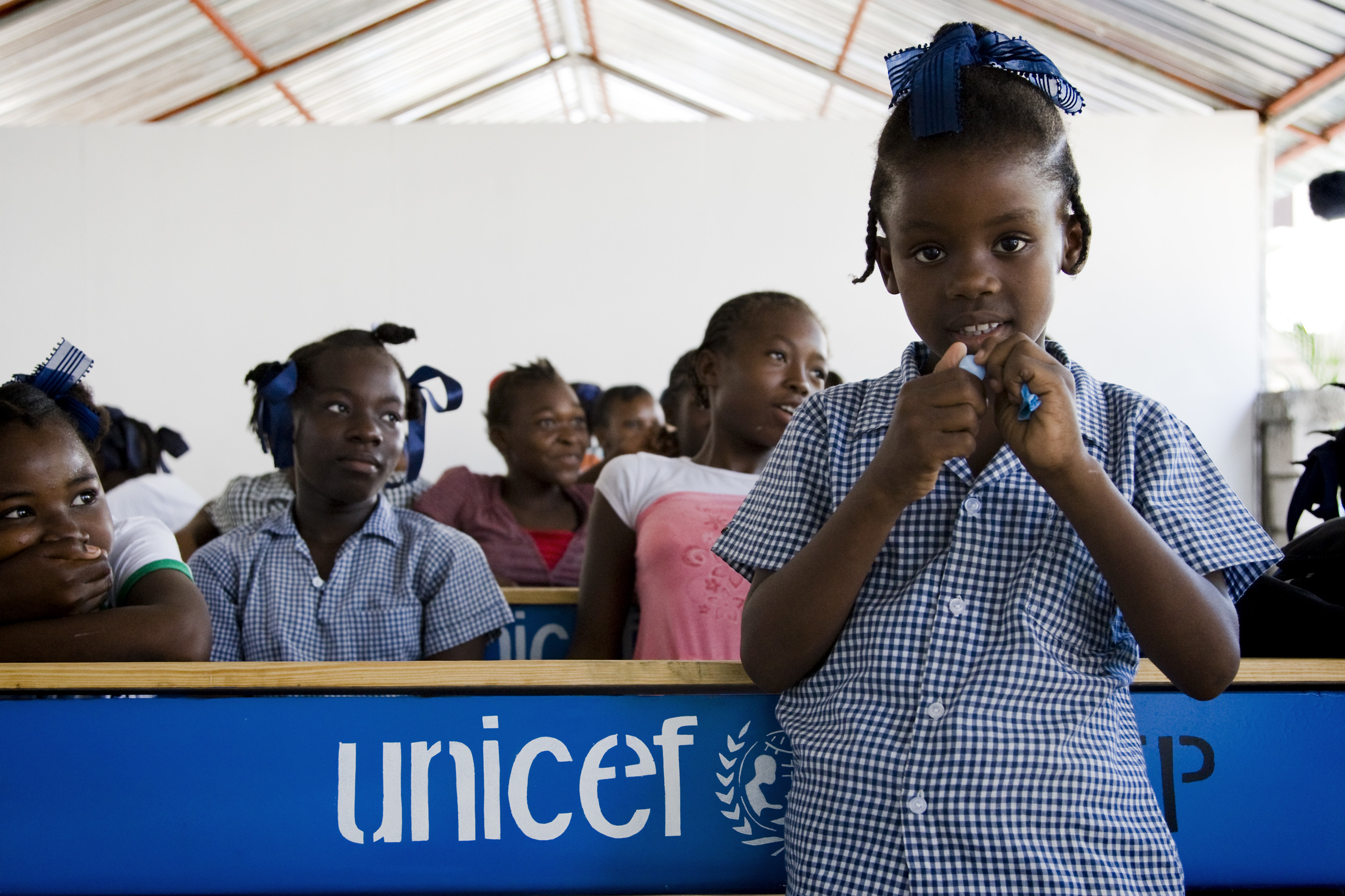A student poses for a photo after the inauguration of the Celie Lilavois school in Port au Prince. The school buildings were destroyed in the quake and UNICEF's construction unit rebuilt it in time for October the 4th, date that marks the beginning of the school season.