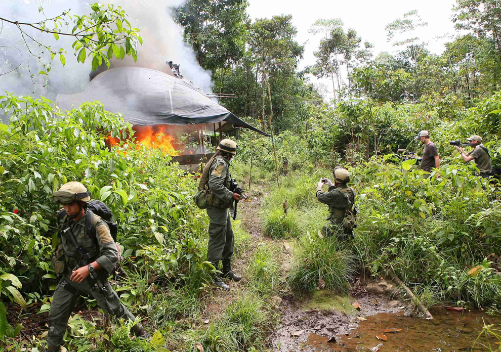Anti-narcotic police officers destroy a cocaine laboratory in Llorente Colombia July 2009 (AP Photo)