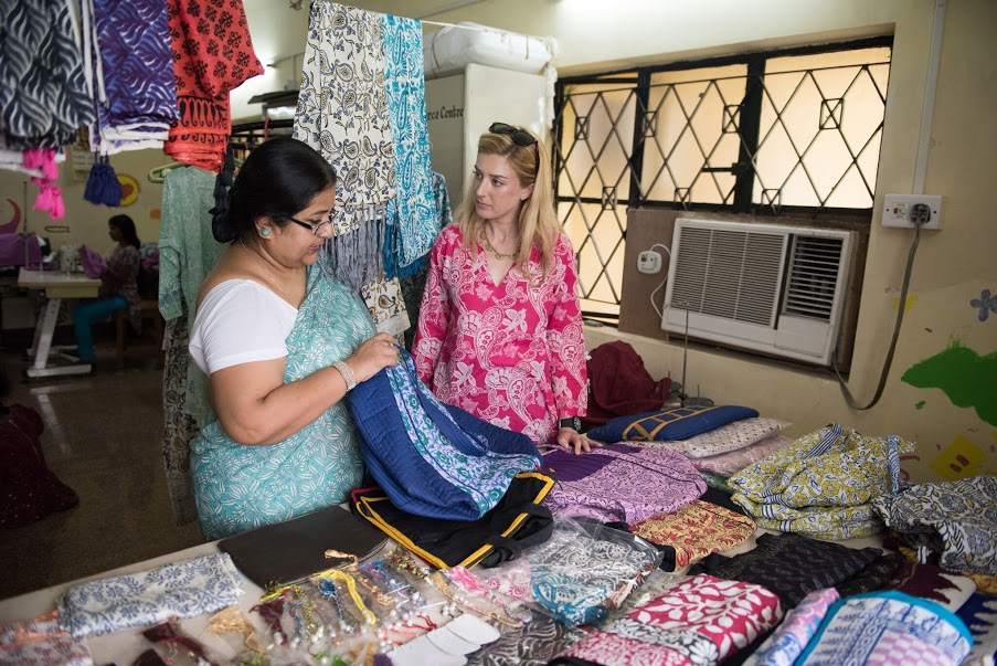 Jane examines products in a Kolkata, India shelter with a shelter staff member_preview
