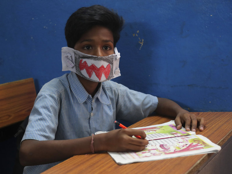A child wears a self-made mask to class in an Indian school.