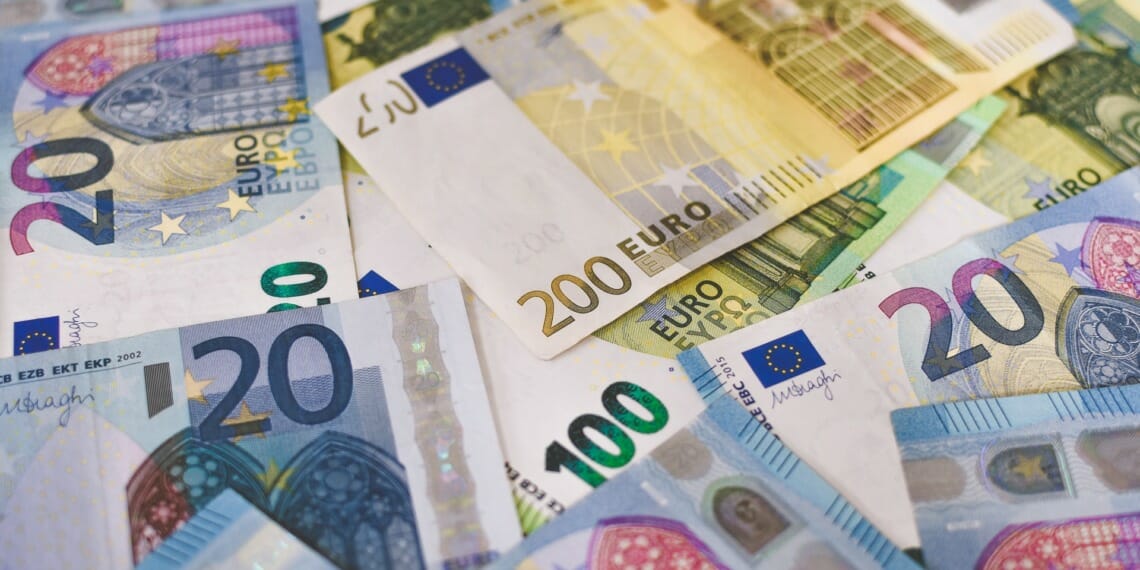 A pile of Euro banknotes that include 20, 100, and 200 notes.