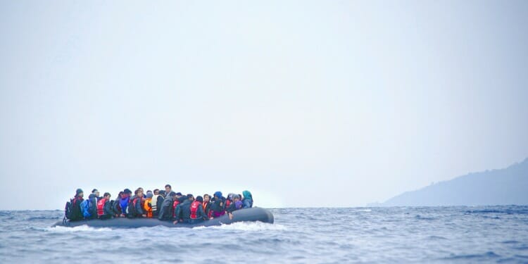 inflatable boat filled with immigrants at sea