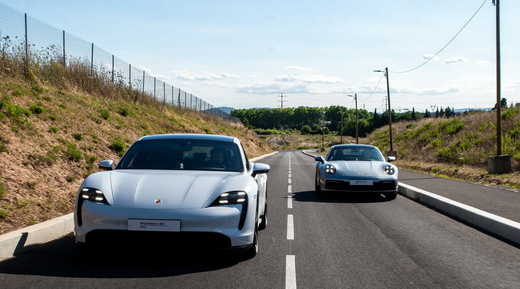 two cars racing on a road