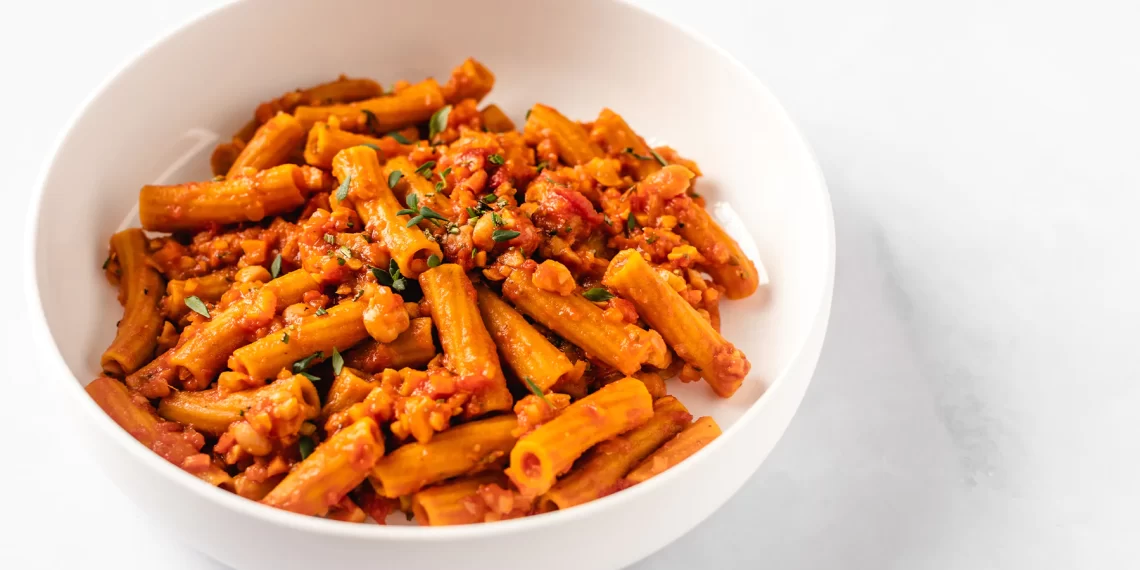 [Image description: A white bowl of pasta on a table. Via Bontasana.]