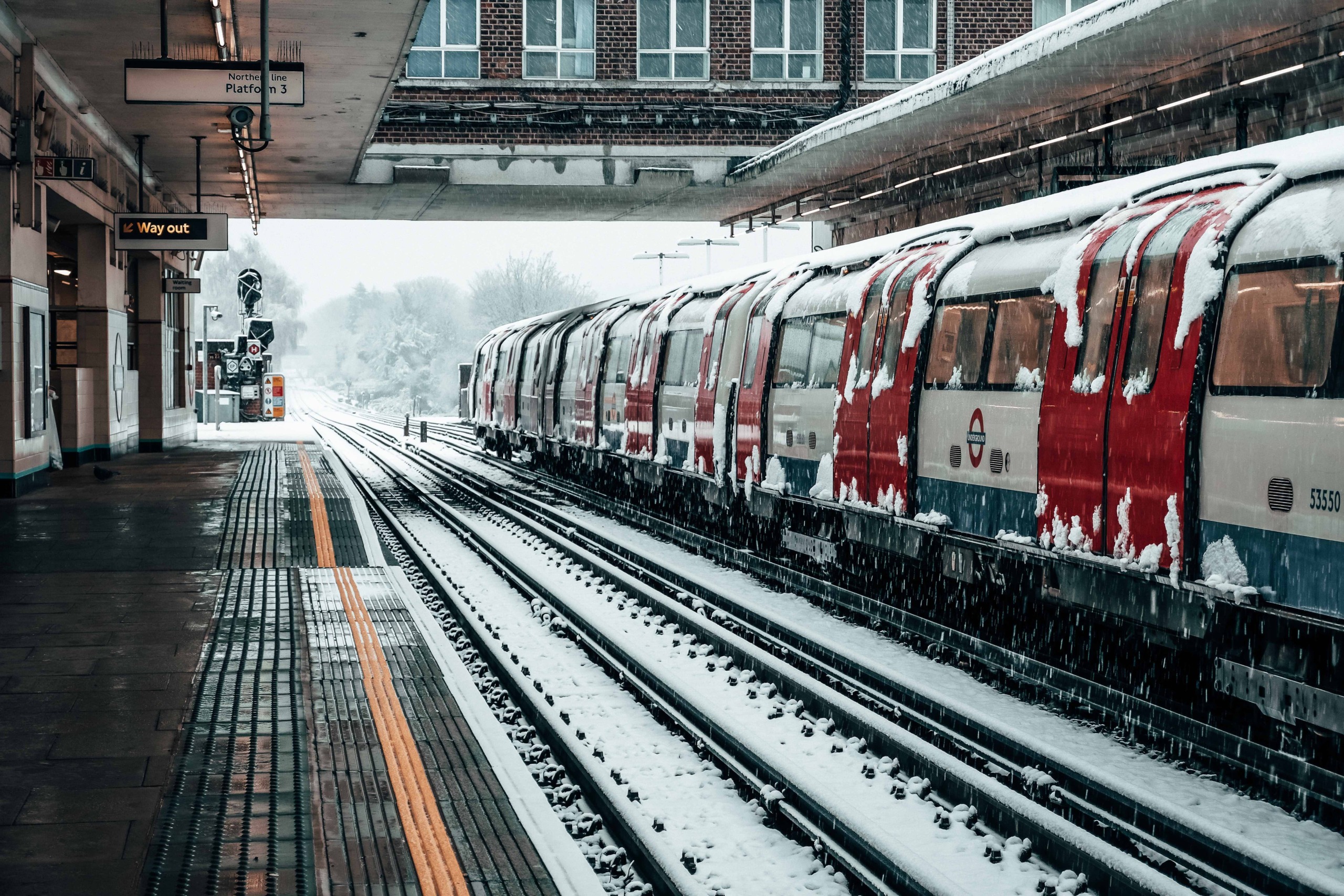 An empty train platform under snow