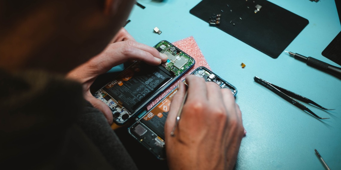 woman fixing smartphone