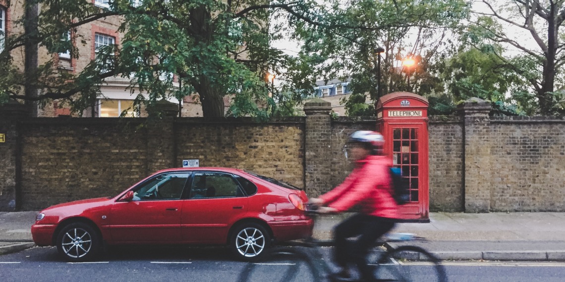 Bicycle and car in London ULEZ Expansion