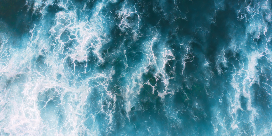 Foaming waves in North Beach in Nazare, Portugal