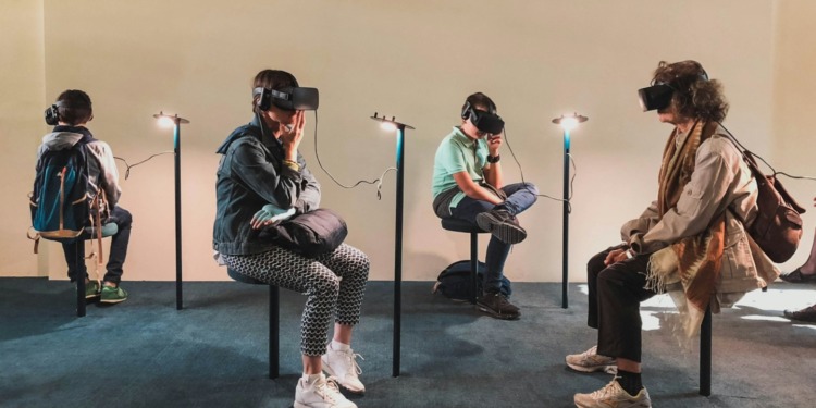 People in a museum using virtual reality headsets. Tech trends to look out for in 2024