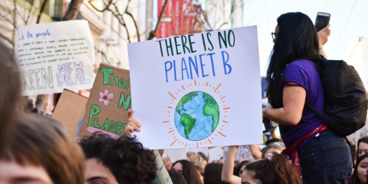 Youngsters hold banners, highlighting Gen Z’s commitment to sustainability and the role of ESG solutions in business.