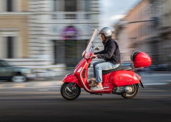 Bike Insurance: red Piaggio vespa riding in Rome