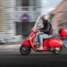 Bike Insurance: red Piaggio vespa riding in Rome