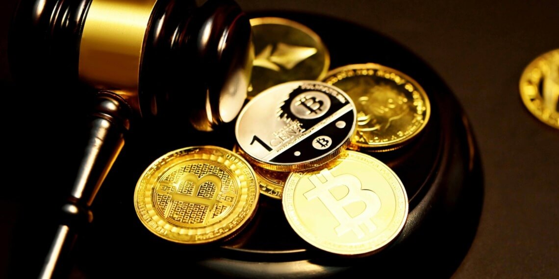 Cryptocurrency coin, calculator and financial documents representing alternative investments