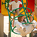 brother and sister playing in a playground