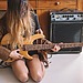 Woman playing an Electro-Acoustic Guitar
