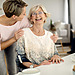 Home Care Support: Cheerful senior woman having fun with her adult daughter at home