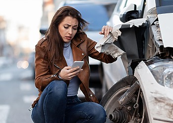 A woman at the crash site, calling your car accident lawyer is key