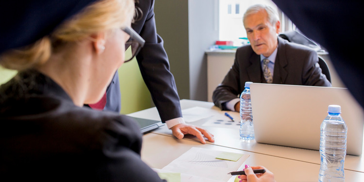 3 Fraud Offences Lawyers in the office going through a case review.