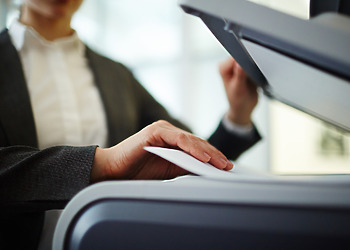 A woman sending a PDF as a Fax From her Computer.