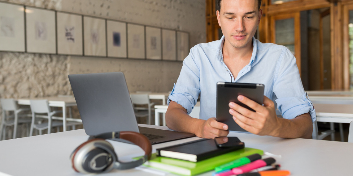 Young developer looking at his LMS With a Mobile App.