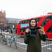 Content production in London - Woman standing with a camera in front of Westminster.