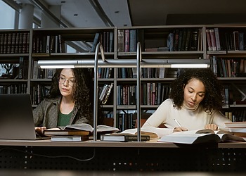 Two women, using their learning skills to leap forward in their studies.