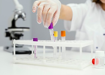 How a girl wearing a lab coat is organising the lab test samples