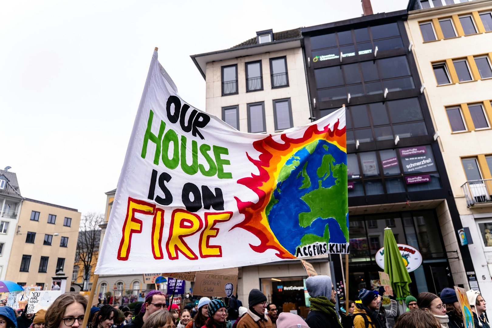 Protest sign that reads "Our House is on Fire"