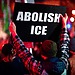 Protestor holding "Abolish ICE" banner