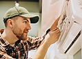 AC Repair Companies: a service man at work on a AC unit.