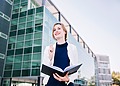 Young woman in front of her university.