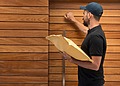 Post man knocking on Chemical-Free Timber Cladding