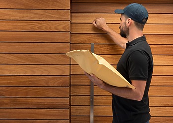 Post man knocking on Chemical-Free Timber Cladding