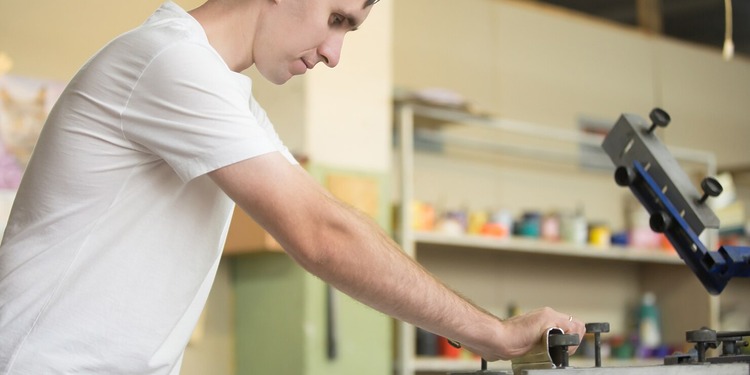 Young man and his Heat Press machine