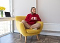 Woman sitting in her living room while enjoying her Ripening Room Humidifier
