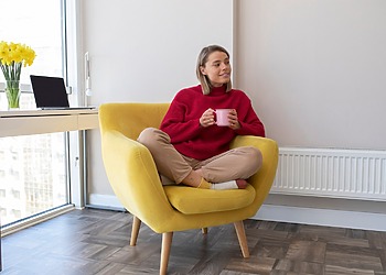 Woman sitting in her living room while enjoying her Ripening Room Humidifier
