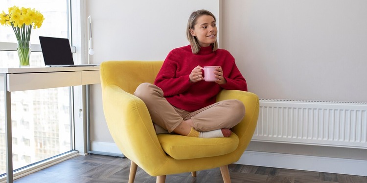 Woman sitting in her living room while enjoying her Ripening Room Humidifier