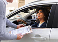 Woman handing over her car insurance