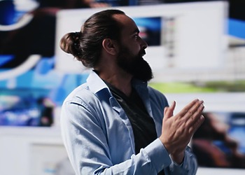 An engineer explaining to his team the innovative software solutions elaborated for their clients.