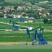 Oil pump jack in desert landscape representing global oil price volatility amid geopolitical tensions