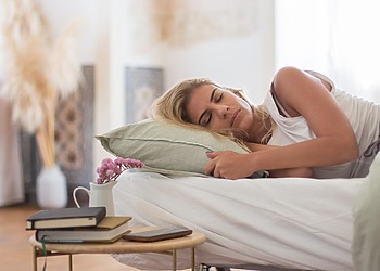 A woman being monitored by sleep physicians which study her sleep patterns.