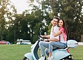 couple riding a Vespa
