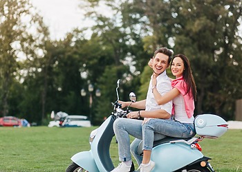 couple riding a Vespa
