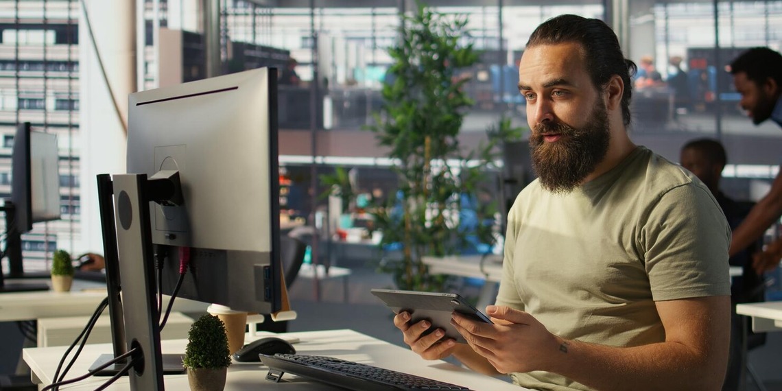 Engineer working on his desktop, focusing on a custom software development solution for his client.
