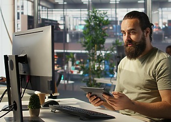 Engineer working on his desktop, focusing on a custom software development solution for his client.