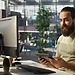 Engineer working on his desktop, focusing on a custom software development solution for his client.