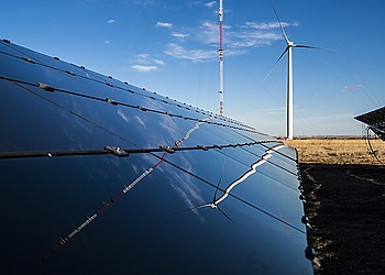 Solar panels and wind turbines representing TotalEnergies and Masdar renewable energy expansion in Asia