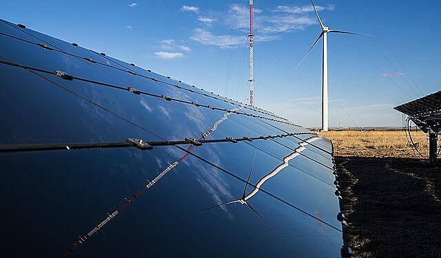Solar panels and wind turbines representing TotalEnergies and Masdar renewable energy expansion in Asia