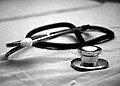 A stethoscope on a table- black an white image