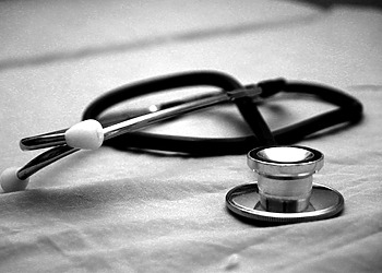 A stethoscope on a table- black an white image